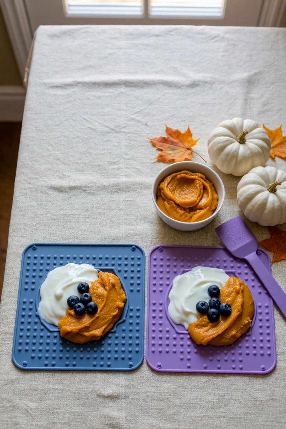blue and purple lick mats with pumpkin and yogurt for a dog