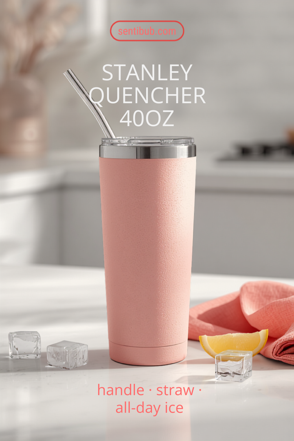 blush-pink Stanley Quencher 40oz tumbler with a handle and straw on a bright kitchen counter